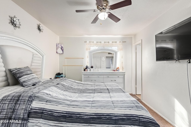 bedroom with ceiling fan and carpet floors