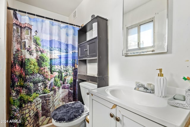 bathroom featuring vanity and toilet