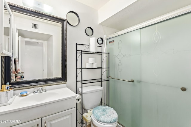 bathroom featuring walk in shower, vanity, and toilet