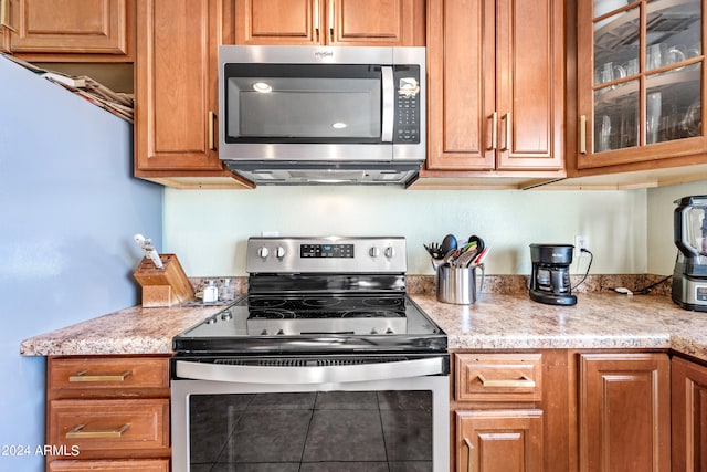 kitchen with light stone counters and stainless steel appliances