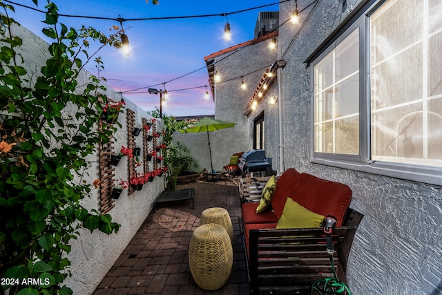 patio terrace at dusk featuring an outdoor hangout area