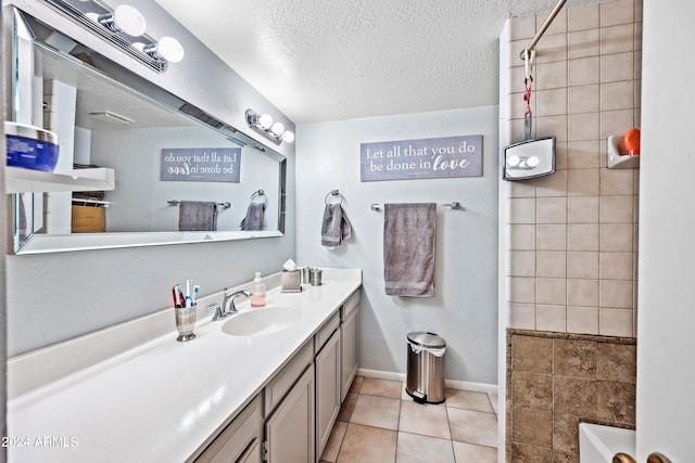 bathroom featuring a textured ceiling, vanity, and tile patterned floors