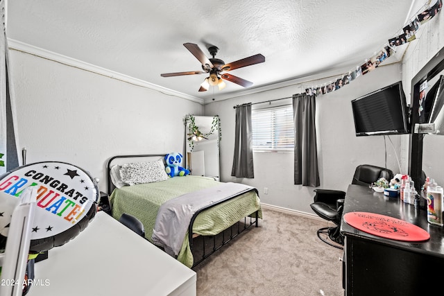 carpeted bedroom featuring a textured ceiling, ornamental molding, and ceiling fan