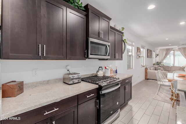 kitchen featuring stainless steel appliances and dark brown cabinets