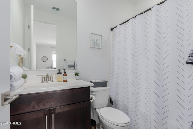 bathroom featuring vanity, toilet, and a shower with shower curtain