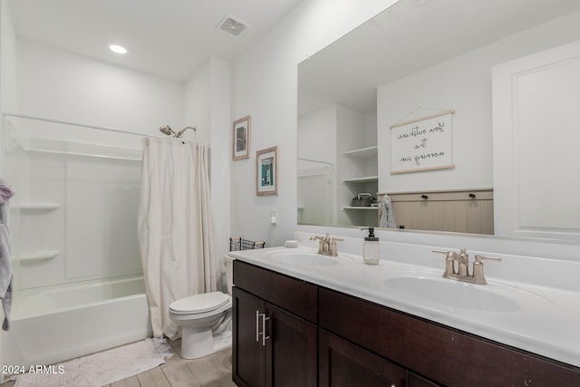 full bathroom featuring shower / bath combo, vanity, and toilet