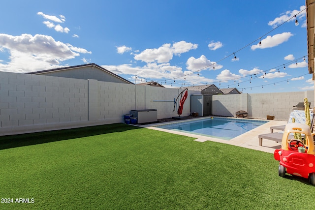 view of pool featuring a yard