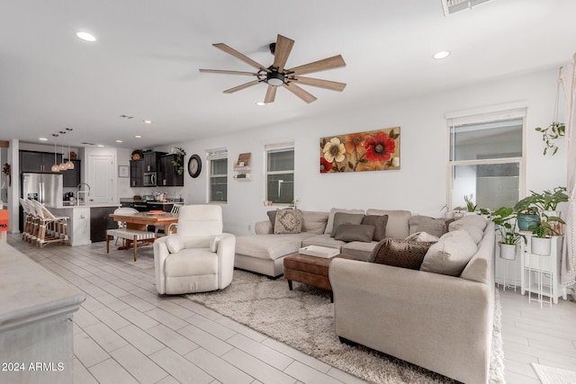 living room featuring sink and ceiling fan