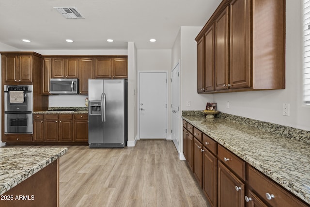 3575 E Gary Way, Gilbert, AZ 85234 - kitchen with appliances with stainless steel finishes, light wood-type flooring, light stone counters, and recessed lighting