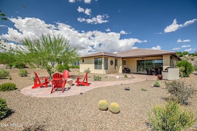 back of house with a patio area, ceiling fan, and a fire pit