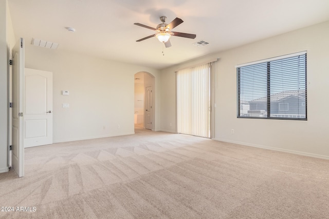 carpeted spare room with ceiling fan