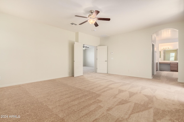 carpeted spare room with ceiling fan