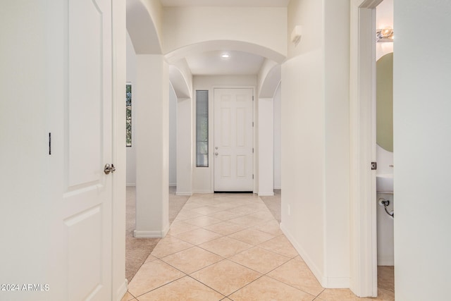 hall featuring light tile floors