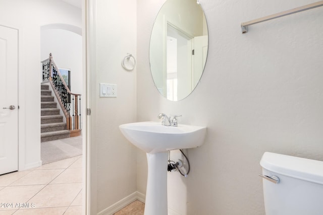 bathroom with toilet and tile floors