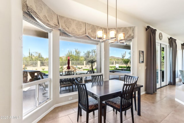 dining area featuring tile patterned flooring and an inviting chandelier