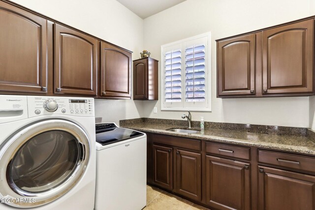 clothes washing area with sink, light tile patterned flooring, separate washer and dryer, and cabinets