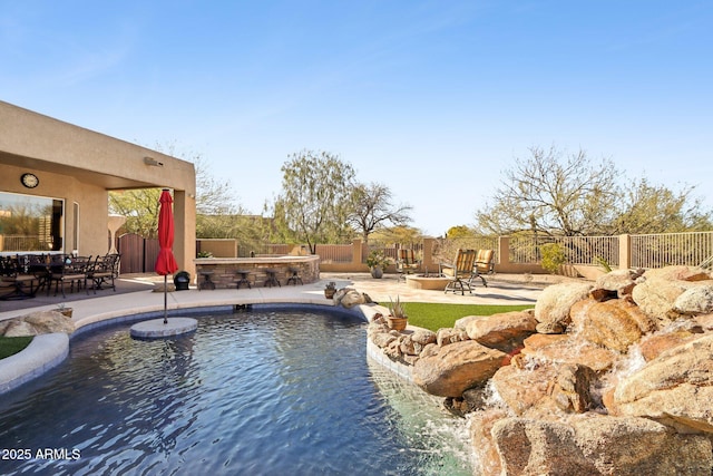 view of swimming pool featuring an outdoor fire pit, a patio area, and pool water feature