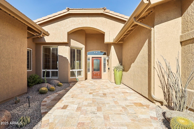 property entrance featuring a patio