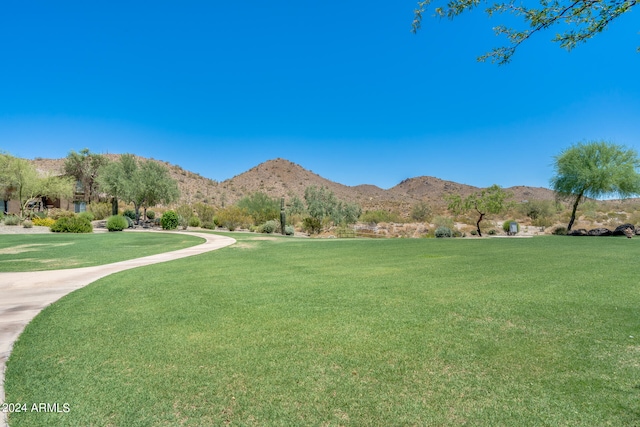 view of community featuring a lawn and a mountain view