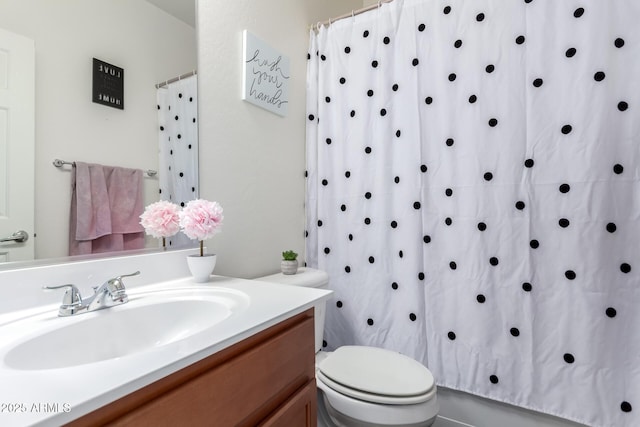 full bathroom with toilet and vanity