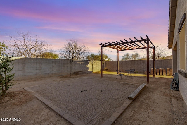 yard at dusk featuring a patio area, a fenced backyard, and a pergola