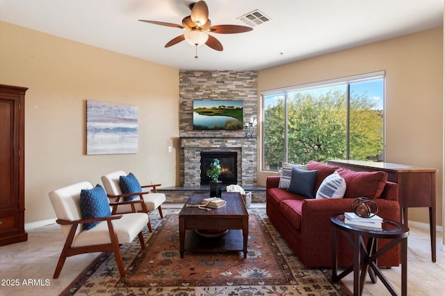 living room with a fireplace and ceiling fan