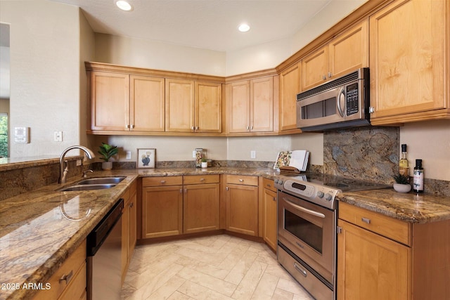 kitchen with decorative backsplash, dark stone counters, stainless steel appliances, light parquet floors, and sink