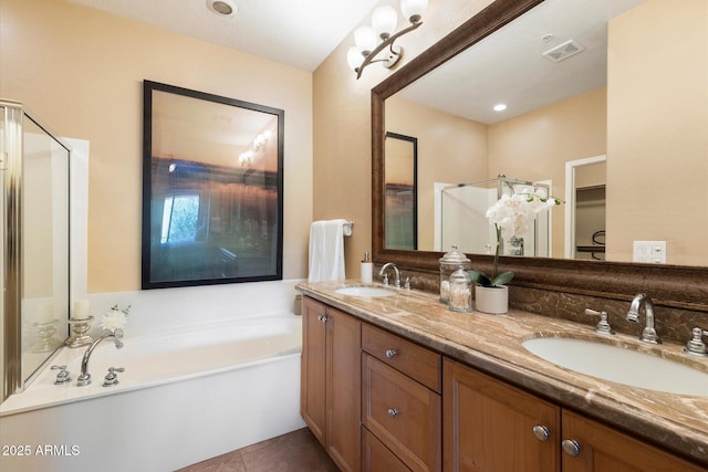 bathroom featuring tile patterned flooring, a bathtub, and vanity