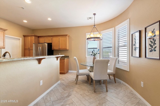 dining room with sink and light parquet floors