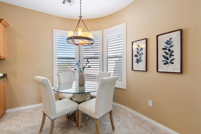 dining area featuring an inviting chandelier