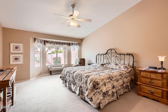 carpeted bedroom featuring baseboards, lofted ceiling, and ceiling fan