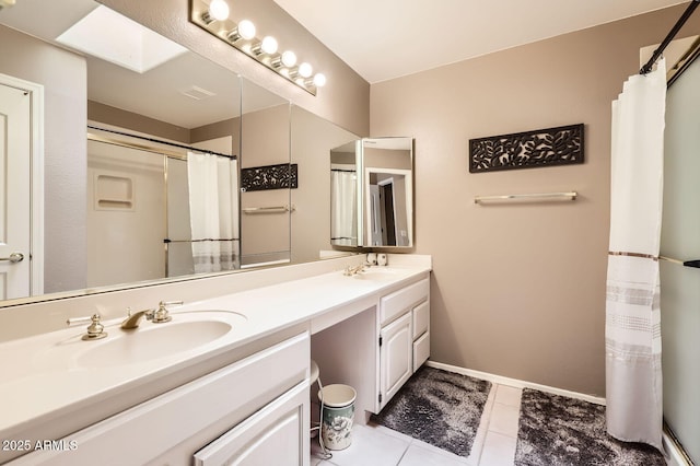 full bathroom featuring tile patterned flooring, visible vents, baseboards, double vanity, and a sink