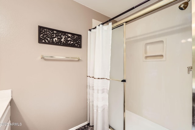 bathroom featuring a shower with shower curtain and baseboards