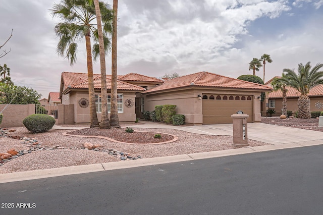 view of front of house featuring stucco siding, fence, concrete driveway, a garage, and a tiled roof