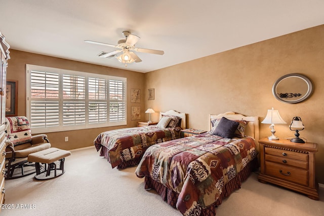 carpeted bedroom featuring visible vents and a ceiling fan