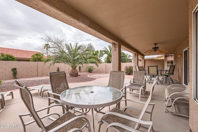 view of patio featuring a fenced backyard, outdoor dining area, and a ceiling fan