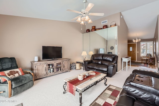 carpeted living room with visible vents and ceiling fan with notable chandelier