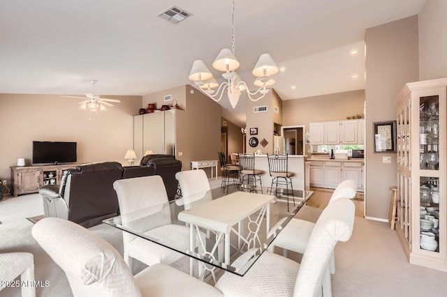 dining room with recessed lighting, visible vents, lofted ceiling, and light colored carpet