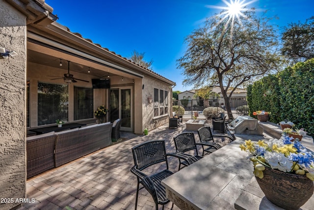 view of patio with ceiling fan, area for grilling, and outdoor lounge area