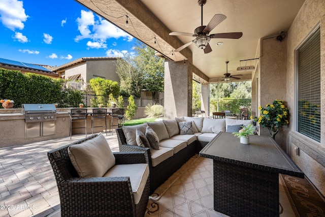 view of patio featuring outdoor lounge area, area for grilling, ceiling fan, and a bar