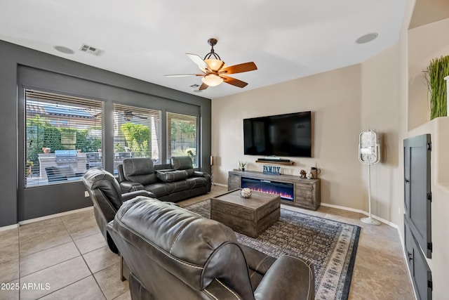 living room featuring light tile patterned floors and ceiling fan