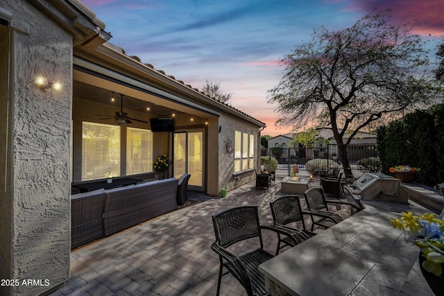 view of patio / terrace featuring an outdoor living space with a fire pit and ceiling fan