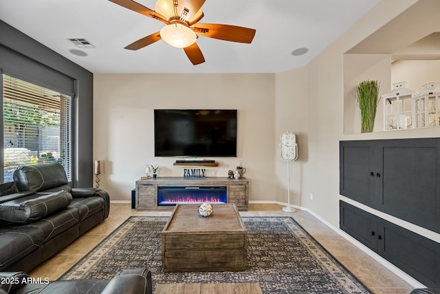 living room featuring tile patterned floors and ceiling fan