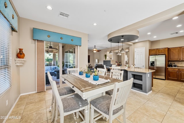 dining area featuring light tile patterned flooring and ceiling fan