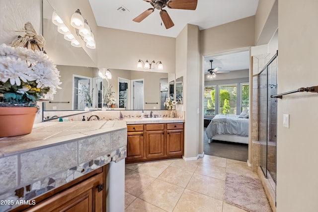 bathroom featuring tile patterned flooring, vanity, ceiling fan, and a shower with shower door