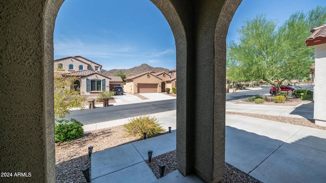 view of yard with a mountain view and a garage