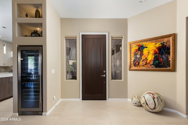 foyer entrance featuring light tile patterned floors and wine cooler