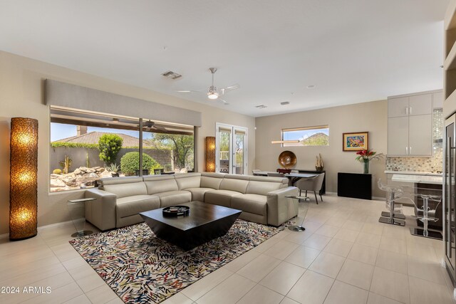 living room with ceiling fan and light tile patterned floors