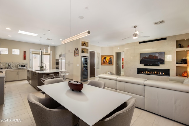 dining area featuring light tile patterned floors, beverage cooler, visible vents, and recessed lighting