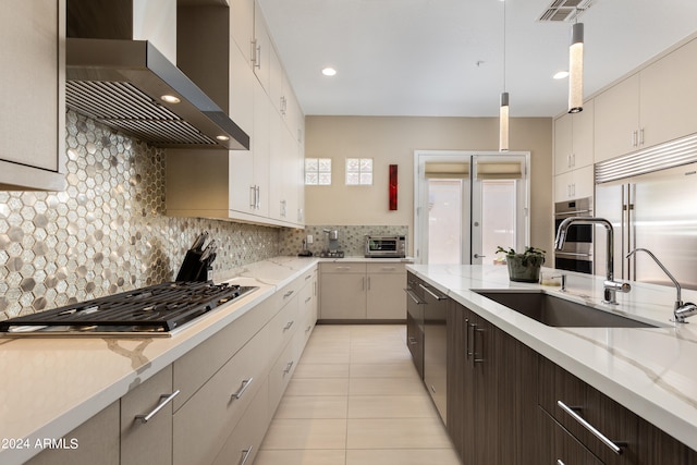 kitchen with wall chimney exhaust hood, pendant lighting, light tile patterned floors, backsplash, and stainless steel appliances